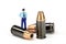 Miniature police officer standing on a bullet