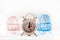 Miniature prams and alarm clock on a white background close-up. Baby and pregnancy concept and copy space. Strollers and watches i