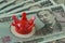 miniature red crown on pile of japanese yen banknotes as financial and economic winning policy concept