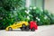Miniature red trailer lift up broken yellow taxi using as transporation concept