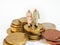 Miniature senior couple stand on pile of Euro coins. Retirement