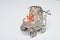 Miniature silver baby buggy containing toy infant