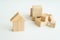 Miniature small house made wooden blocks background of a stack of cubes for assembly.