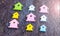 Miniature Symbol of Various Coloured Houses laying symmetric on dark wooden surface