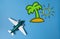 Miniature toy airplane and summer island draw on blue
