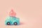 Miniature toy blue car delivering pink thread heart for Valentin