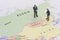 Miniature two businessman shakehand on china and russian map