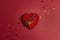 Miniature violin on the heart on the red background. Love for music concept