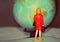 Miniature woman looking at the globe. Mini figure from behind with a globe round map model, travel global concept