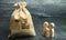 Miniature wooden family figurines stand near a money bag. The concept of savings. Budget planning. Distribution of profits.