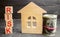 Miniature wooden house, dollars and the inscription ` Risk `. Buying a house, apartment and financial risks. Loss of property for