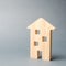 Miniature wooden house on a gray background. Real estate. Long-term rental apartments. Affordable housing for young families.