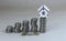 Miniature wooden house on a stack of coins. Concepts for property, banking and finance, real estate acquisition