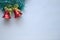 Miniature wooden sledge carrying a small gift next to a decorative Christmas tree made of wood with a little squirrel on a green