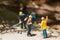 Miniature workmen clearing fallen trees