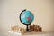 Miniature world globe model standing on chess wooden board