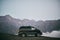 Minibus mountains in the background. Bus for transportation of tourists. Mount Kazbegi.