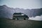 Minibus mountains in the background. Bus for transportation of tourists. Mount Kazbegi.