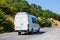 Minibus Moves Along Country Road in the Mountains