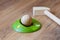 Minigolf wood for kids. Golf club and a ball during a mini golf game. Children`s Games at Home