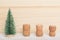 Minimal christmas concept, decorative Christmas tree and three corks of champagne on a wooden board in a row, copy space