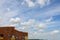 Minimal city scenery brick building cloudy sky summer sun