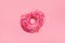 Minimal composition of flying pink donut. Sweet doughnut on pastel background