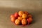 Minimal composition - A net of clementines on brown paper