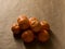 Minimal composition - A pile of clementines on brown paper