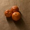 Minimal composition - three clementines on brown paper