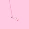 Minimal concept of catching love. Arrangement made of a shiny ring with a heart shaped pink gem on a fish hook. Soft pop pink