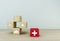 Minimal concept idea about of health and medical insurance, arranging block color stacking with icon healthcare medical on wooden