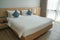 Minimal double bed with white mattress in luxury hotel bedroom