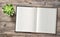 Minimal flat lay Open book succulent wooden background
