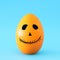 minimal and funny Halloween holiday concept. Orange egg with scary cute face.