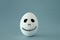 minimal and funny Halloween holiday concept. white egg with scary cute face.