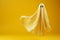 Minimal Halloween spook ghost sheet soars against yellow background