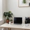 Minimal home-office with open blank screen laptop computer and office supplies on white wooden table