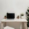 Minimal home-office with open blank screen laptop computer and office supplies on white wooden table