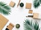 Minimal Office desk table with stationery set, supplies and palm leaves. Top view