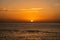 Minimal orange sunset over the Red Sea and Sudanese mountains on the horizon, tranquil evening, seen from a ship