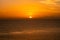 Minimal orange sunset over the Red Sea and Sudanese mountains on the horizon, tranquil evening, seen from a ship