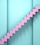 Minimal pastel colored 3d illustration of pink ladder with steps near a blue wall background