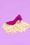 Minimal popcorn background and fashion lady shoes. Still life vertical design.  Diet, fast food, calory concept