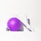 Minimal purple ball  with brunch decor in white trendy space. Fashion still life art. Merry Christmas / Happy New Year holidays