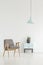 Minimal room interior with a retro armchair, small cabinet with