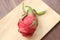 Minimal still life photography. A dragonfruit on wooden background