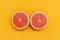 Minimal style, creative layout orange and grapefruit. Flat lay. Food concept. Half an orange on yellow background.