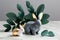 Minimal style Easter eggs, bunny rabbit, eucalyptus leaves on marble table. Generative ai