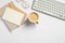 Minimal style feminine workspace. Modern office desk with computer keyboard, coffee cup, glasses, notebook, envelope, blank paper